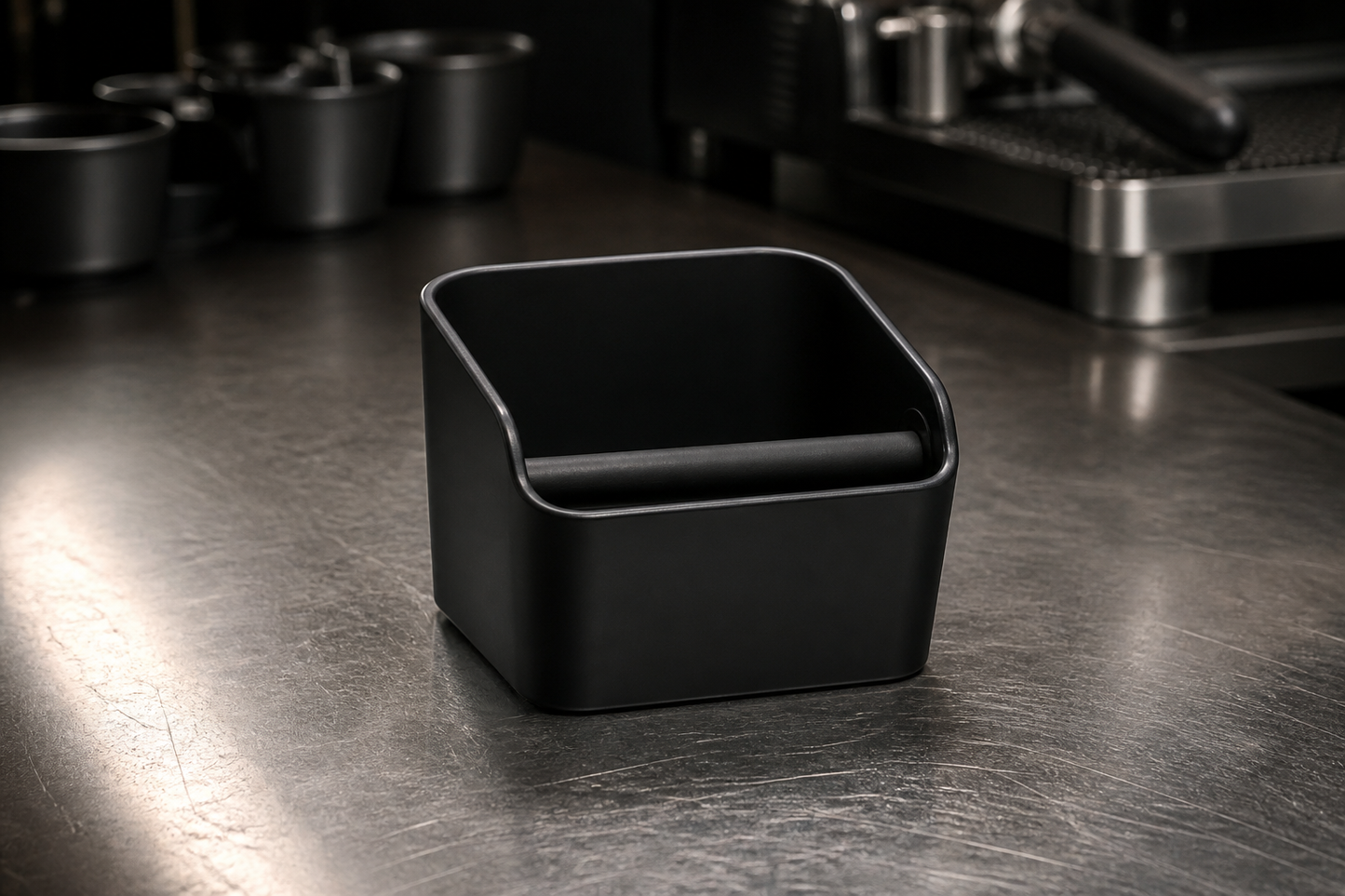 Matte-black knock box on a steel bar